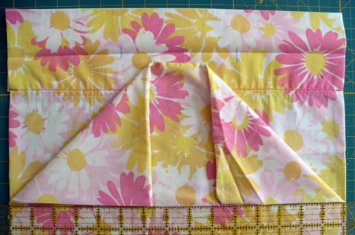 To do so, make sure that the bottom fold that you just made is about 14 inches on both sides from the fold - this should leave about a 1 inch gap between the seamed edge and the fold.