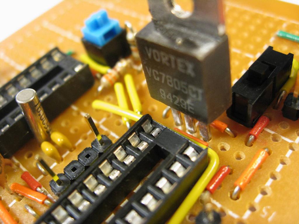 Place the voltage regulator as shown near the power switch and solder.