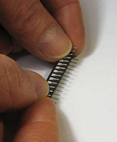 If these chips have not been used before, their pins will be splayed out and will not fit into the sockets; carefully place each side of the chip against a flat surface