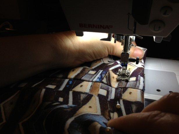 left hand and guiding in the fabric with your right, ensure that you you keep your fabric casing flat and that