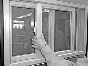 With index fingers, slide tilt latches (on top of sash on both sides) down towards window sill until latches clear the head jamb