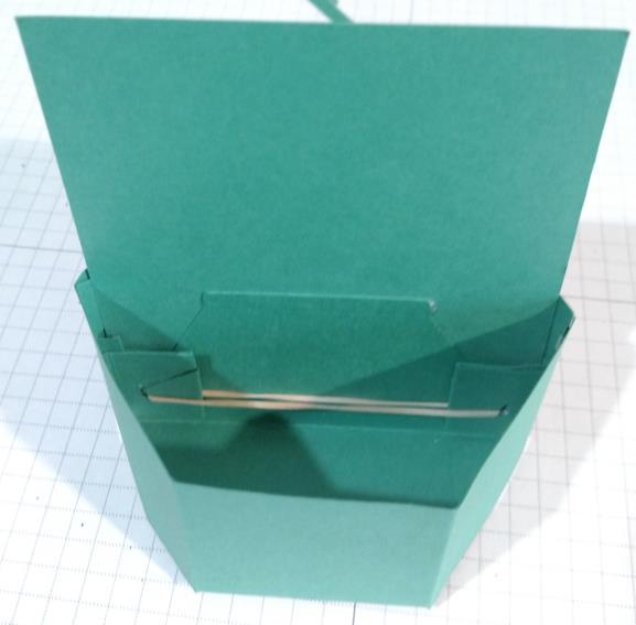 Once rubber band is seated the tiny triangle, test the box by gently squeezing it together.