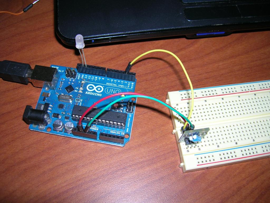 The symbol on the sensor is connected to GND on the Arduino. The middle pin is connected to 5V on the Arduino.
