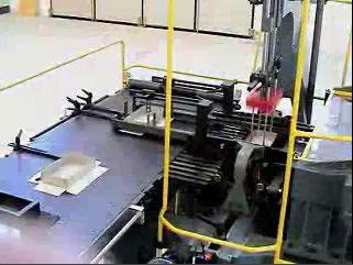 In an automated line, the spotting station appears as it does in Image 8. If you look closely at the top center of the shot you can see a machine-positioned base descending toward the wrap below.
