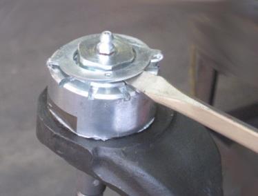 To remove the ball joint stud from the knuckle, use a 5Lb metal hammer to hit the bottom of the end forging.
