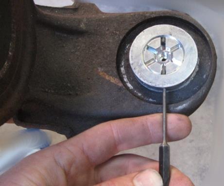 2: Use small punch to remove the roll pins from the lower ball joint (Roll