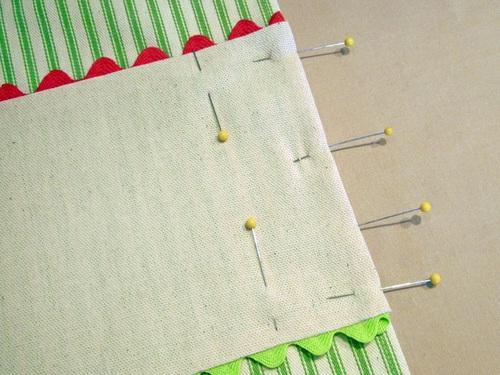 You only need to fold under the sides about ½"; trim any excess so the fold isn't too bulky. Pin the sides in place. 14.