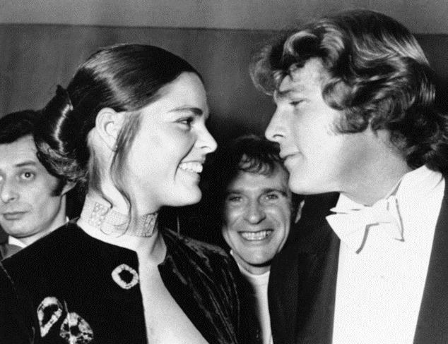 FILE- In this March 8, 1971, file photo, Ryan O'Neal, right, and Ali MacGraw smile after their arrival at the Odeon Theatre, Leicester Square in London, to attend the Royal Film showing of "Love