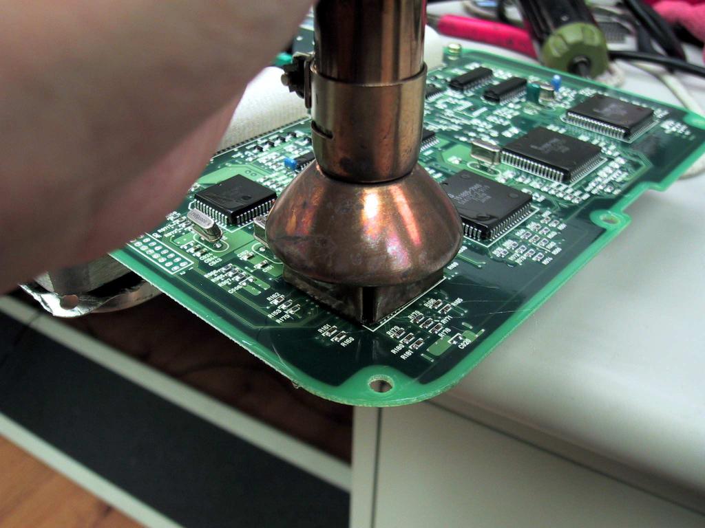 Start with applying little solder to two of the each corner of the pads on the circuit board.