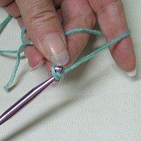 Holding the 'tail' of the slip knot with your thumb and