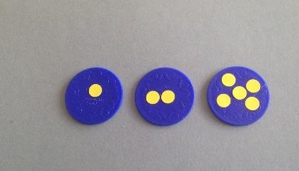 for a value of two. For extension work, pupils will need tokens with 5 dots. The only way to tell the value of a particular counter should be to count the number of dots on it.