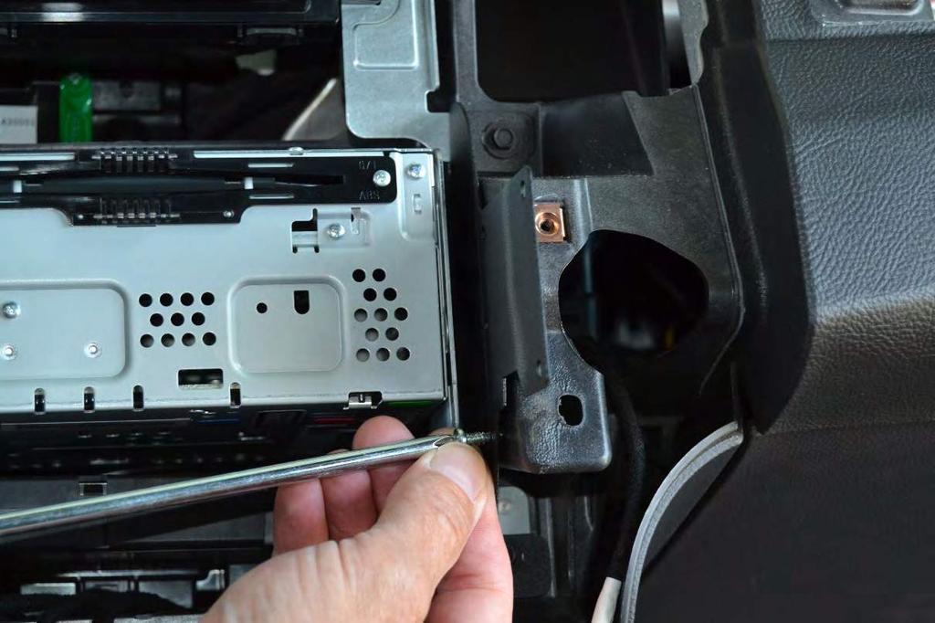21. Using the self-tapping screws in the side holes on the bracket, attach the bracket to the vehicle dash frame. 22.