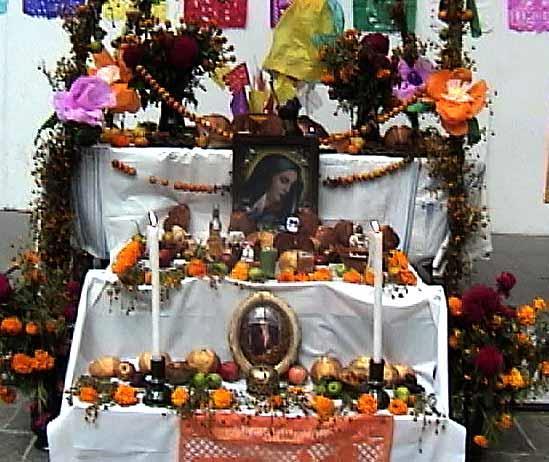 In the homes families arrange ofrenda's or "altars" with flowers, bread, fruit and candy. Pictures of the deceased family members are added.
