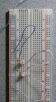 If you connect these two identical resistors as shown, will they together draw more or less current than one of the resistors alone? 3.