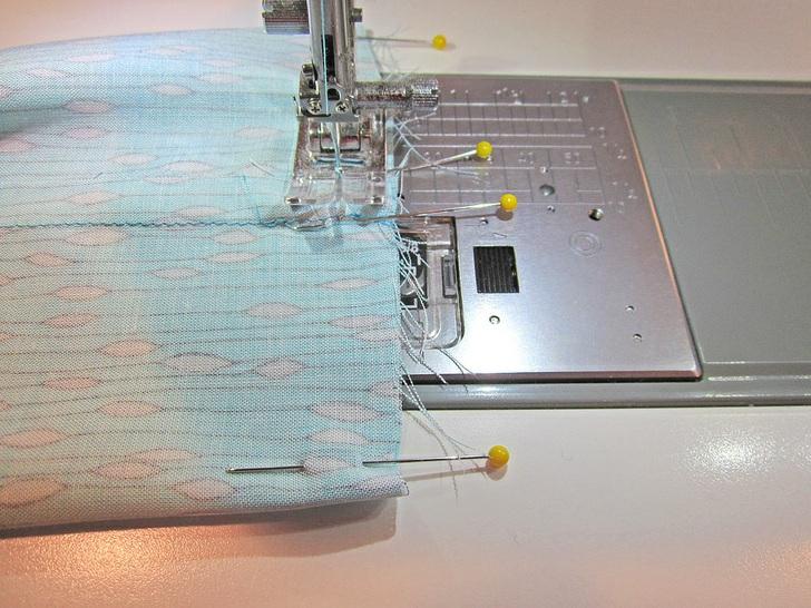11. Using a ½" seam allowance, stitch across the end of the scarf. Stop and lock your seam at the first pin. 12.