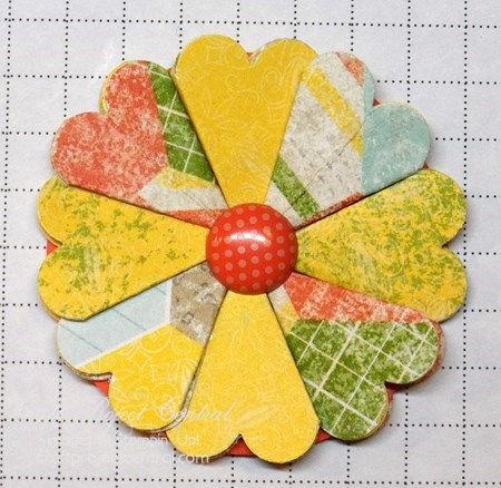 Make sure the bottom point of each petal is just next to the hole,