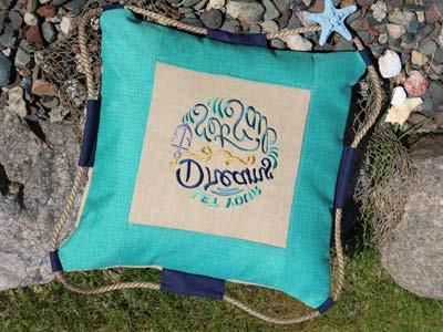Seaworthy sayings adorn this outdoor patio pillow, while jute rope adds an extra nautical touch.