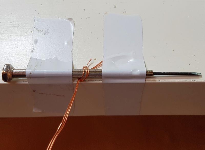 When you have unwound the wire and straightened it, cut it into three approximately equal pieces.