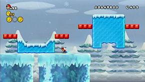 The final coin of the level is just past the area with the "ice cube conveyor