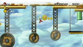 Carefully hop across the wheels below to get to the coin, then take the pipe at the end up