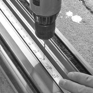 Drill a second 3/32" pilot hole at 20" out from the side jamb (FIGURE 2). 3. Repeat Steps 1 and 2 for the opposite side of the sill track. 4.