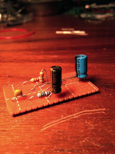 Solder a 2.2µf capacitor between rows H and K in column H.