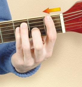 Keeping the major chord formation, you then slide your fingers along the fingerboard toward the bridge by one fret and form a barre by using your index finger to press down all the strings one fret