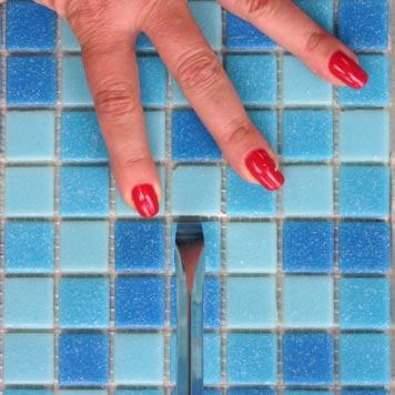 Step 13: Remove Chipped or Imperfect Tiles Using one hand to hold down the tiles adjacent to the tile you want to replace,