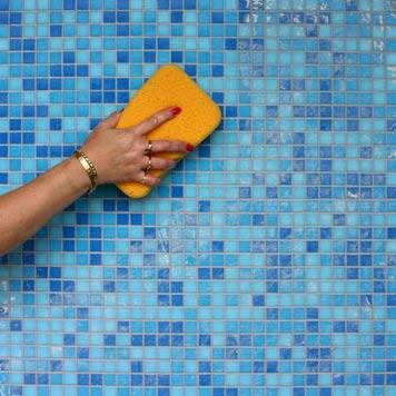 Step 22: Clean Excess Grout from the Tile Surface Using a damp sponge, gently clean the grout from the face of the tiles.