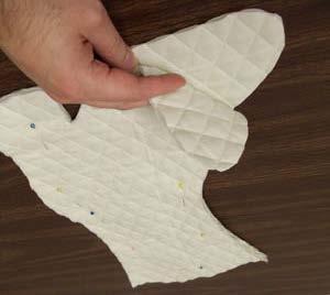 To prepare the inner lining fabric, use the pattern and cut two pieces of quilted cotton.