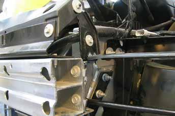 Using a 10 MM socket, remove the four bolts and the air dam from below the bumper.
