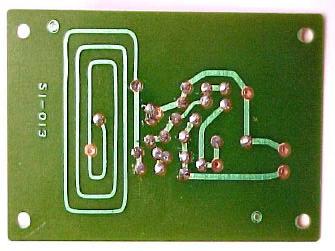 Install the jumper in the circuit board (on the tan side) by putting one end through the hole below label L1 and the other through the hole below label R3.