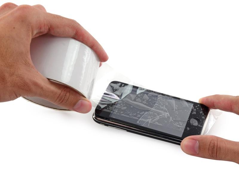 Lay overlapping strips of clear packing tape over the iphone's display until the whole face is covered.