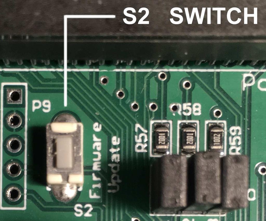 Push and hold the firmware update button switch S2. Turn on power then after two seconds, release S2 and verify the power light is on.