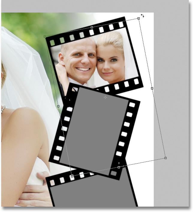 This tells Photoshop to clip the photo to the shape on the photo area layer below it, and now, only the area of the photo that falls within the boundaries of the shape remains visible in the document.