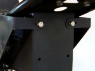 bottom: The rear of the belt guard attaches at the frame tab shown below.