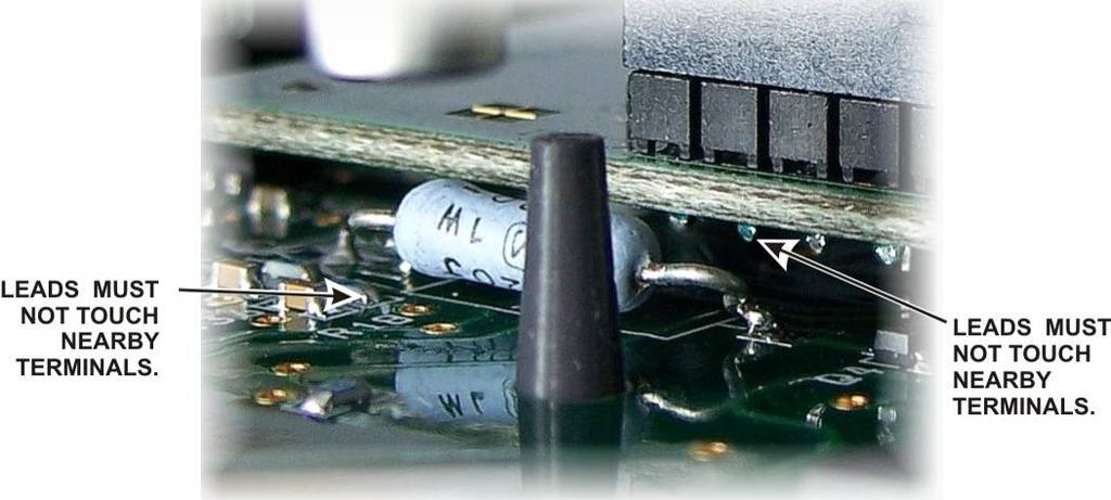 Squeeze the boards together while ensuring the pins are mating with the connectors until the DSP board is resting against the three standoffs on the back of the front panel board that you installed