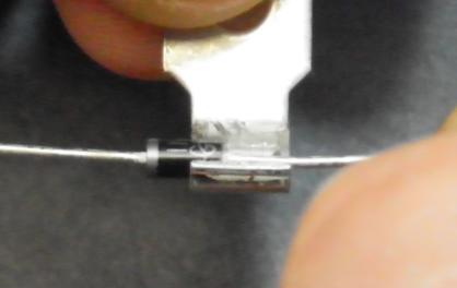 Using needle nose pliers or screwdrivers, open the wire crimp section of the ring terminal to make a u