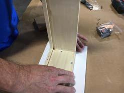 Lay drawer front face down and dab some glue in all