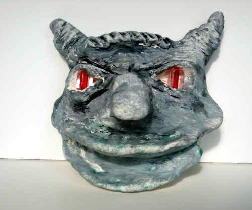 Process of painting a gargoyle face: 1. Cover working area and hand out cups of water, plates of paint (black, white, green and red paint), paint brushes and small squares of sponges.