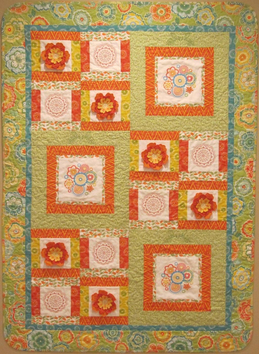 The colors of this quilt will keep you smiling long after the summer flowers are gone for the season. Flowers in Bloom!