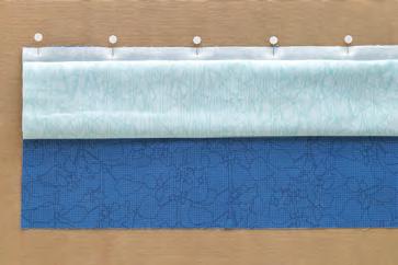 Bring over roll of main fabric and match to raw edge at top of work surface.