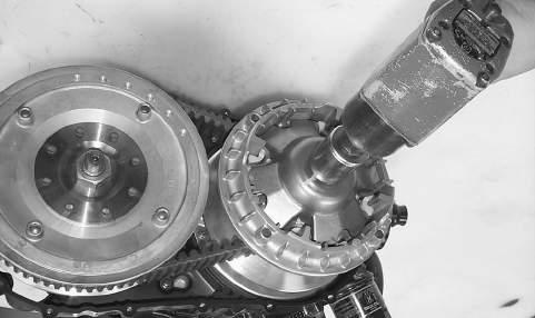 Remove the snap ring securing the water pump drive gear; then remove the gear noting the direction of the sides of the gear for installing purposes. Account for the drive gear alignment pin. Fig.