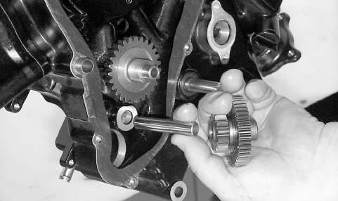 3. Install the two starter gear shafts; then install the two starter gears (with the beveled side of