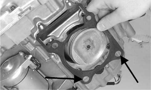 Route the cam chain up through the cylinder cam chain housing; then remove the piston holder and seat the cylinder firmly on the crankcase.