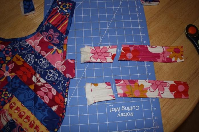 Pin down one neck strap and one waist strap. Lay out the Velcro as shown below and sew it into place.