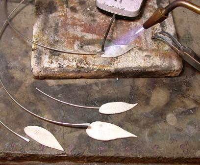 (Editor s Note: Dried leaf skeletons found at craft stores can be rollprinted onto silver sheet to achieve a similar effect.) Solder the leaves. Flux a leaf and the flattened end of the 8-in. (20.