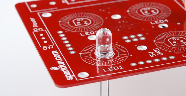 3 Insert the LED into the PCB, so that the short leg goes into the hole labeled with the -