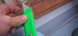 Using the utility knife, cut away the thickest parts of the sealant. Try not to nick the wood.