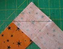 Now sew this strip to the bottom edge of the center panel, with the top end of the zipper pointing left.